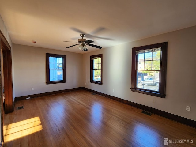 unfurnished room with ceiling fan and hardwood / wood-style floors