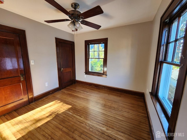 spare room featuring wood-type flooring and ceiling fan