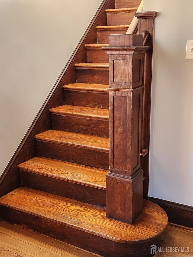 stairway featuring hardwood / wood-style floors