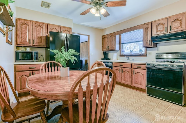 19 W Joffre Ave W, Milltown, NJ 08850 - kitchen with stainless steel appliances, under cabinet range hood, light countertops, a ceiling fan, and brown cabinetry