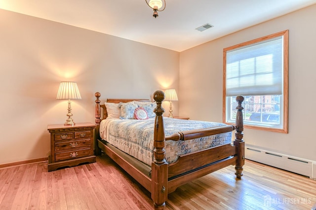 19 W Joffre Ave W, Milltown, NJ 08850 - bedroom featuring a baseboard radiator and light wood-style floors
