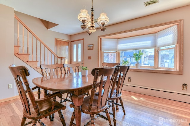 19 W Joffre Ave W, Milltown, NJ 08850 - dining room with a chandelier, light wood-type flooring, baseboard heating, and stairs