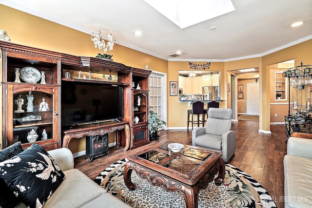 living area with a skylight, baseboards, wood finished floors, and crown molding