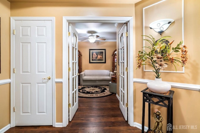 hallway with dark wood-style floors and french doors