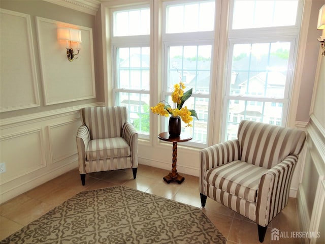 sitting room featuring tile patterned floors and a decorative wall