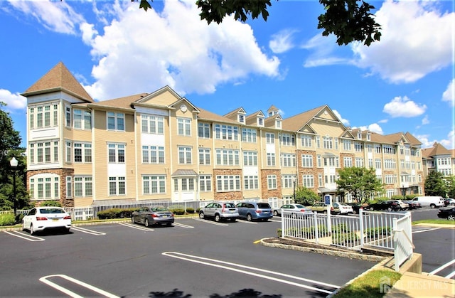 view of building exterior featuring uncovered parking