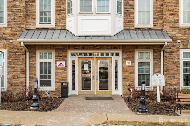 entrance to property featuring metal roof and a standing seam roof