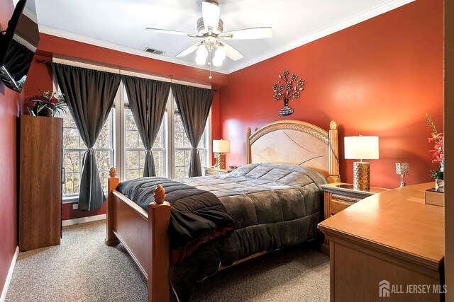 bedroom with a ceiling fan, carpet, visible vents, and ornamental molding