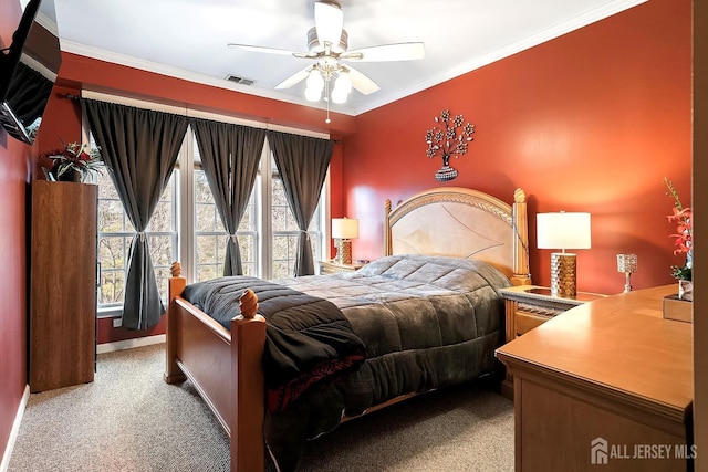 bedroom featuring visible vents, ornamental molding, ceiling fan, and carpet floors