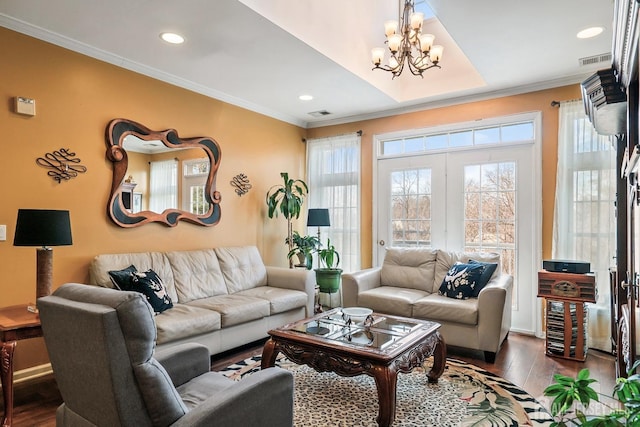 living room featuring visible vents, dark wood-type flooring, ornamental molding, recessed lighting, and a notable chandelier