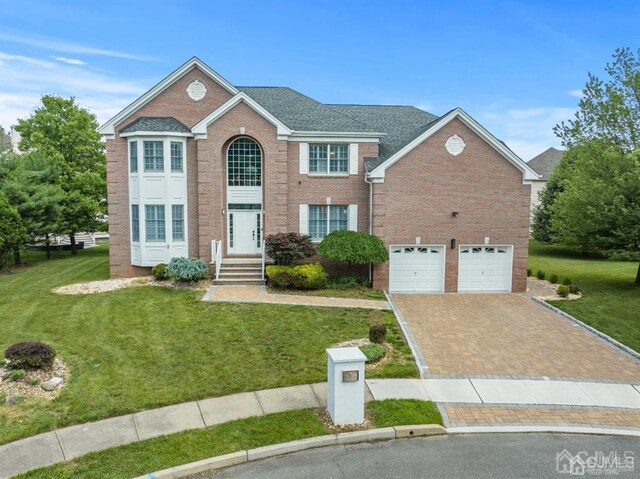 view of front of property featuring a garage and a front yard