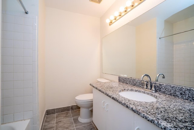 full bathroom with vanity, tiled shower / bath, tile patterned floors, and toilet