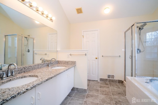 bathroom with vanity, plus walk in shower, tile patterned flooring, and vaulted ceiling