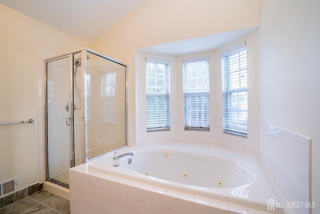 bathroom featuring separate shower and tub and vaulted ceiling