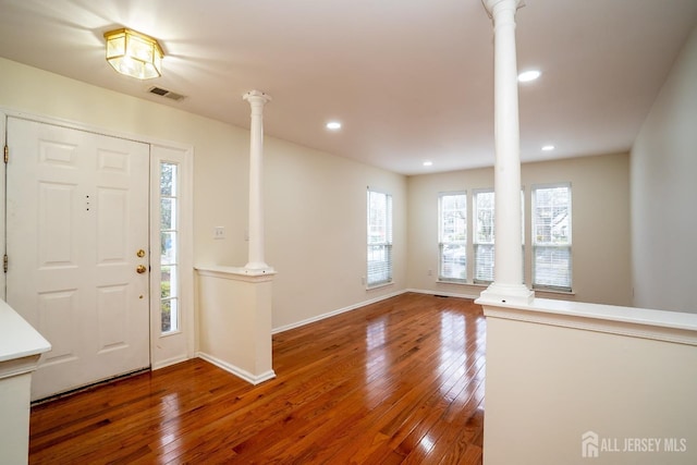 entrance foyer with hardwood / wood-style flooring and ornate columns