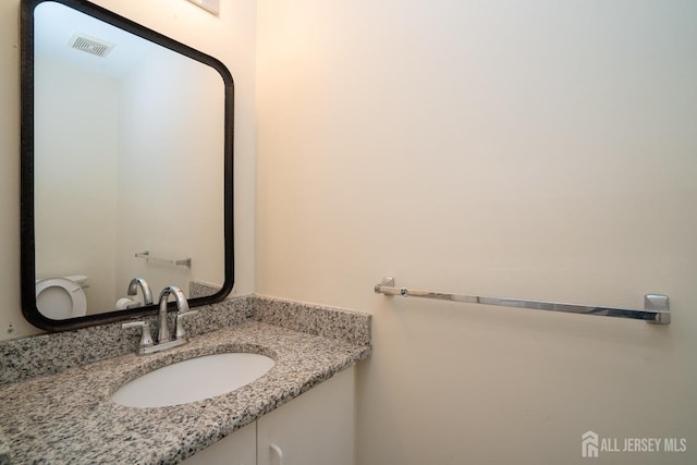 bathroom with vanity and toilet