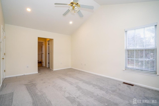 unfurnished room featuring high vaulted ceiling, light colored carpet, and ceiling fan