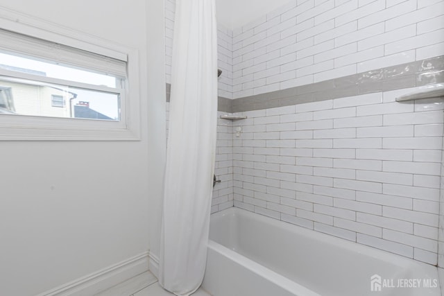 94 2nd St, Keyport, NJ 07735 - bathroom featuring baseboards and shower / tub combo with curtain