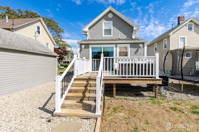 94 2nd St, Keyport, NJ 07735 - back of property featuring a trampoline, a deck, and stairway