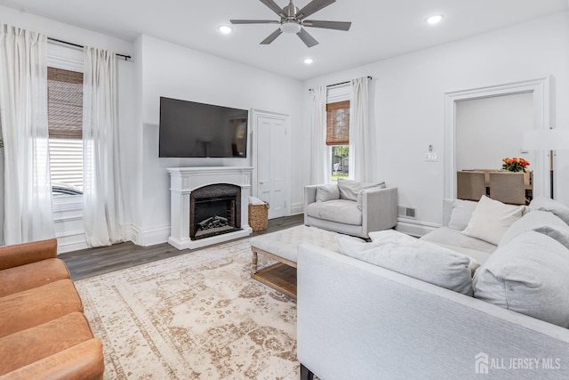 94 2nd St, Keyport, NJ 07735 - living area featuring a ceiling fan, wood finished floors, a fireplace with raised hearth, recessed lighting, and baseboards