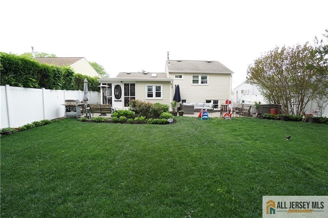 rear view of house with an outdoor living space, a sunroom, and a patio area