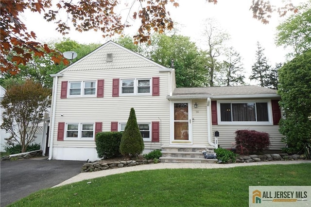 split level home featuring a front yard, driveway, and entry steps