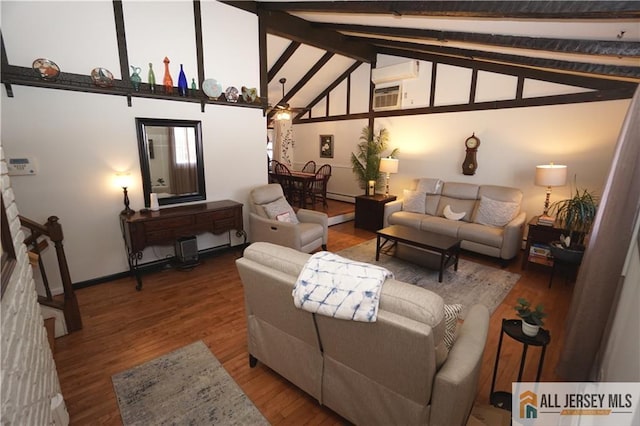 living room with wood finished floors, beam ceiling, baseboards, high vaulted ceiling, and a wall unit AC