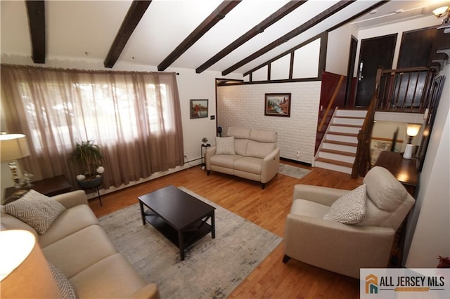 living area featuring wood finished floors and stairs