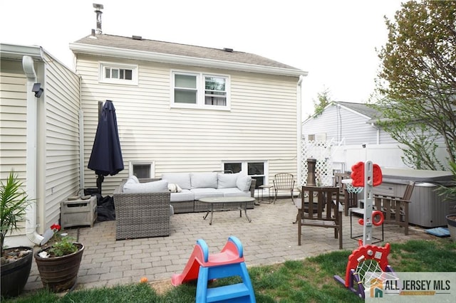 view of patio / terrace featuring a hot tub, an outdoor living space, and fence