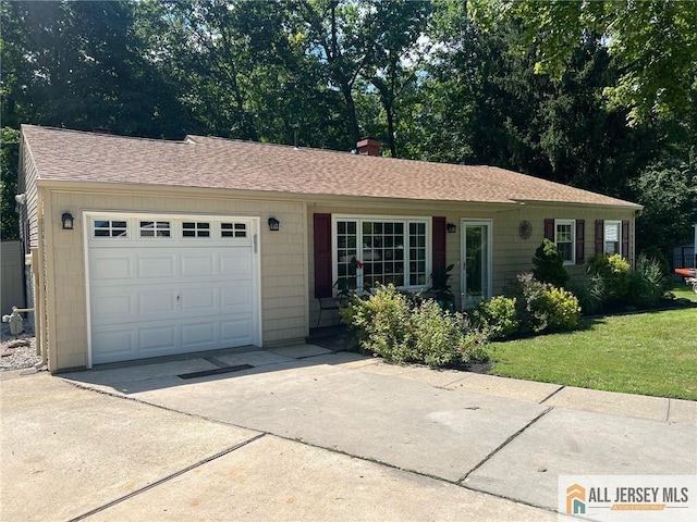 single story home featuring a front yard and a garage