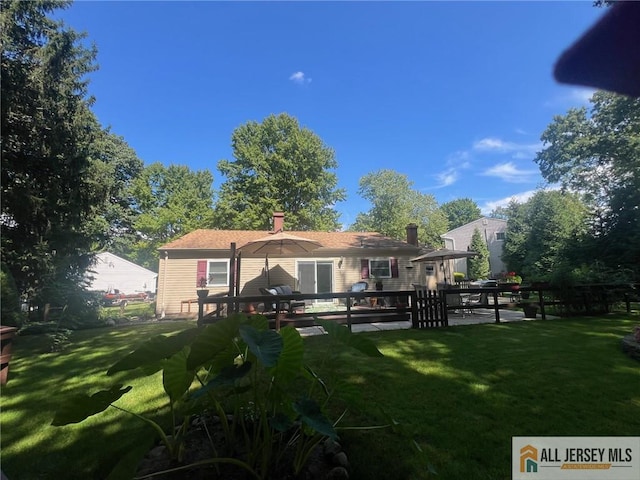 back of property featuring a yard and a patio