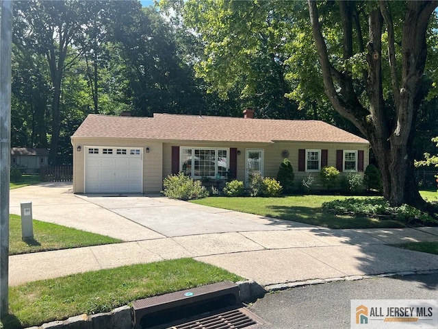 single story home featuring a front yard and a garage