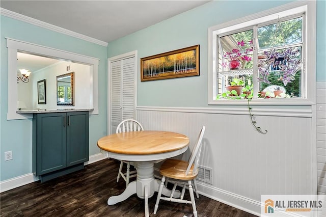 dining area featuring crown molding and dark hardwood / wood-style floors