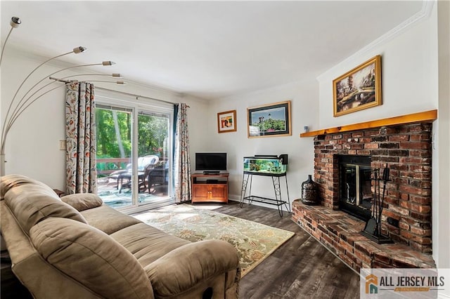 living room with ornamental molding, a fireplace, and dark hardwood / wood-style flooring