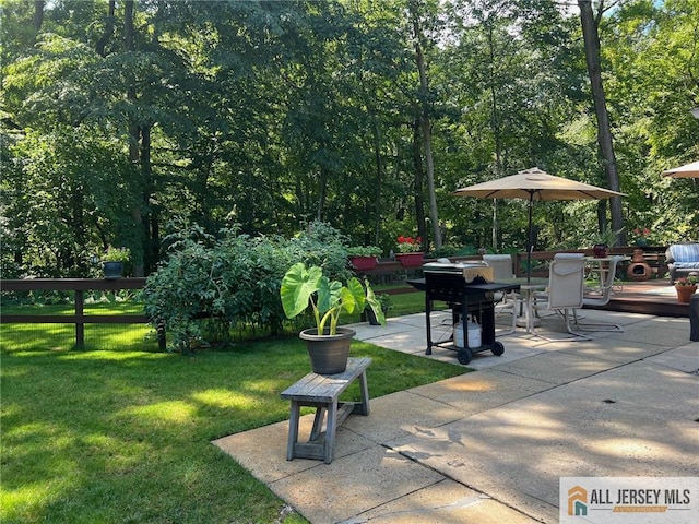 view of property's community with a yard, a patio area, and a wooden deck