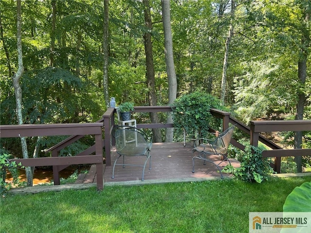 wooden deck with a lawn