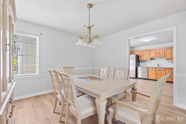 334 Waterside Blvd, Monroe, NJ 08831 - dining room with light wood-style floors, plenty of natural light, a chandelier, and a textured ceiling