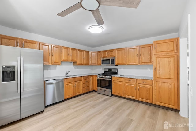 334 Waterside Blvd, Monroe, NJ 08831 - kitchen with stainless steel appliances, light wood finished floors, ceiling fan, and light stone countertops