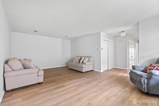 334 Waterside Blvd, Monroe, NJ 08831 - living area with a textured ceiling and light wood finished floors