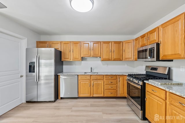 334 Waterside Blvd, Monroe, NJ 08831 - kitchen featuring appliances with stainless steel finishes, light stone counters, and light wood-style flooring
