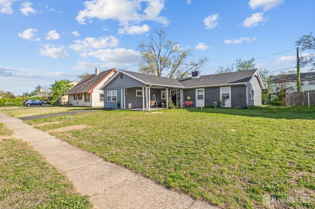 view of front of house with a porch, a front lawn, and fence
