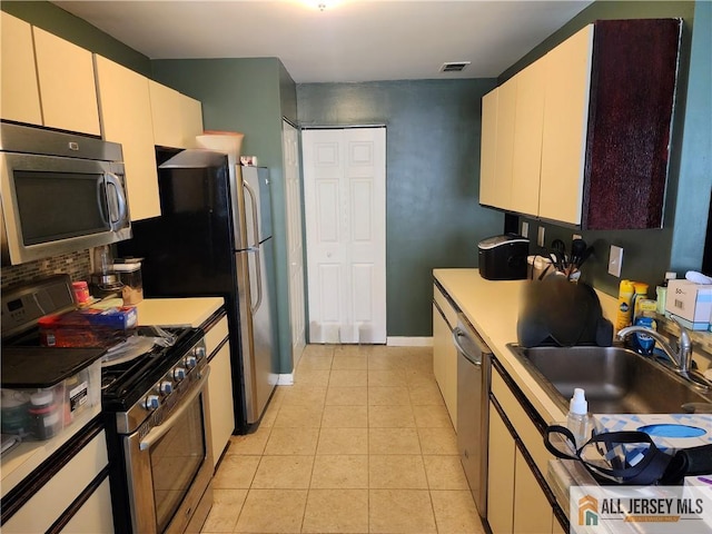 6232 Cedar Ct, South Brunswick, NJ 08852 - kitchen featuring stainless steel appliances, a sink, light tile patterned floors, light countertops, and decorative backsplash