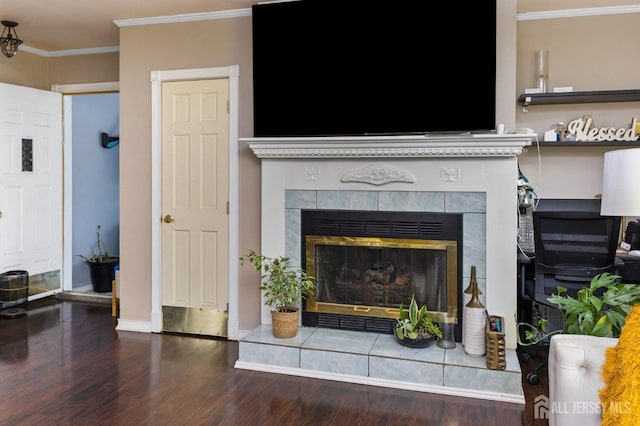 details with a tile fireplace, crown molding, wood finished floors, and baseboards