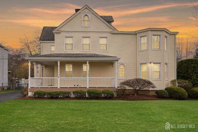 92 Main St, Helmetta, NJ 08828 - view of front of house featuring covered porch, a front lawn, and a shingled roof