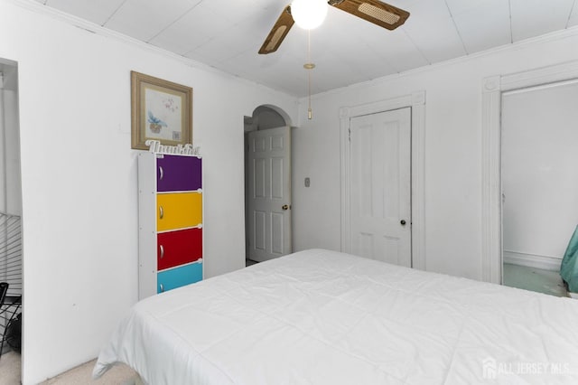 bedroom featuring ceiling fan and crown molding