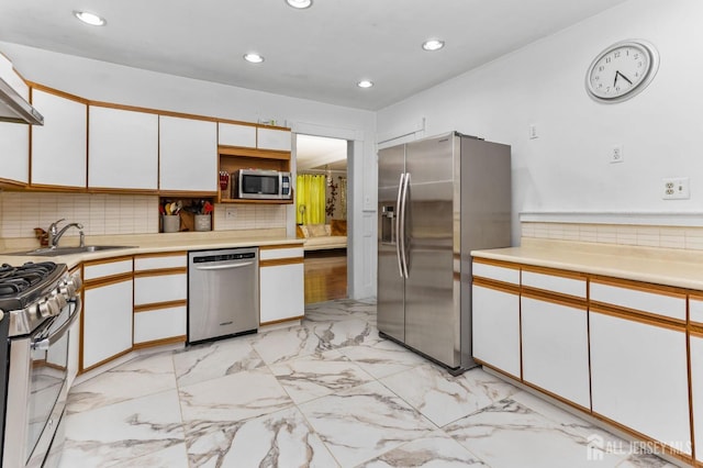 92 Main St, Helmetta, NJ 08828 - kitchen featuring appliances with stainless steel finishes, white cabinets, recessed lighting, decorative backsplash, and light countertops
