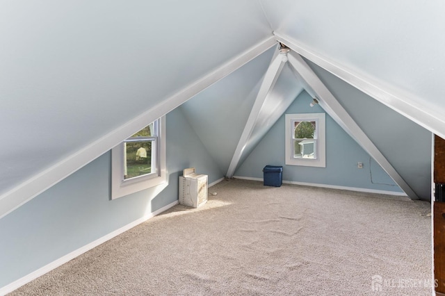 bonus room featuring carpet flooring, baseboards, and lofted ceiling
