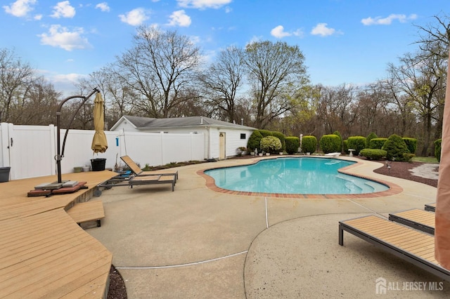 92 Main St, Helmetta, NJ 08828 - view of swimming pool featuring a fenced backyard, a patio, a wooden deck, and view of wooded area