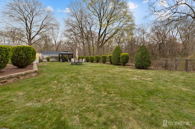 view of yard featuring a gazebo and fence