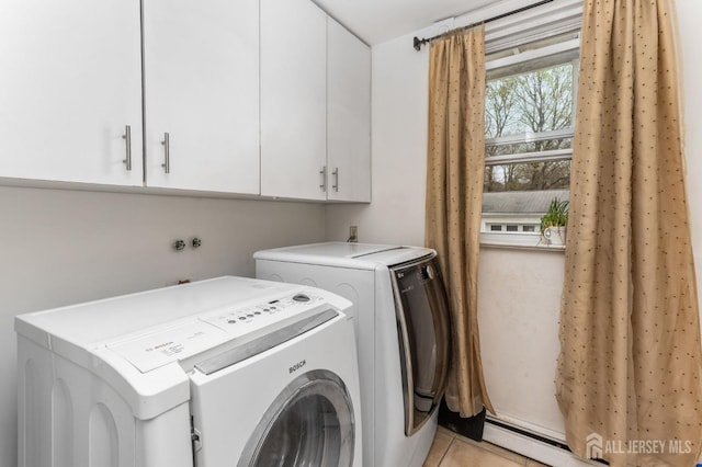 clothes washing area with cabinet space, light tile patterned floors, and independent washer and dryer